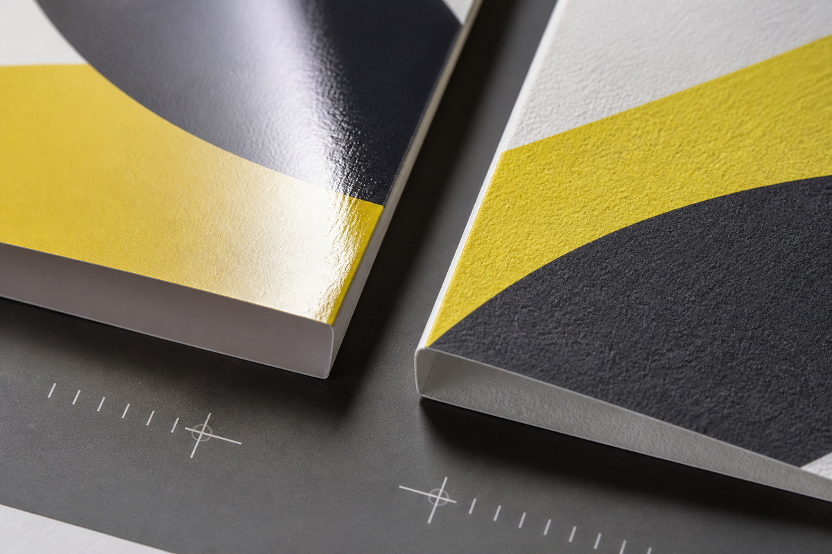 Macro comparison of glossy coated stock and textured uncoated paper edges